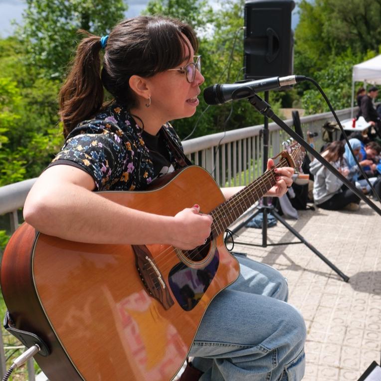 persona tocant la guitarra